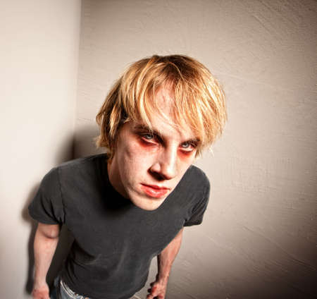 Young Male Zombie Standing in a Cornerの写真素材