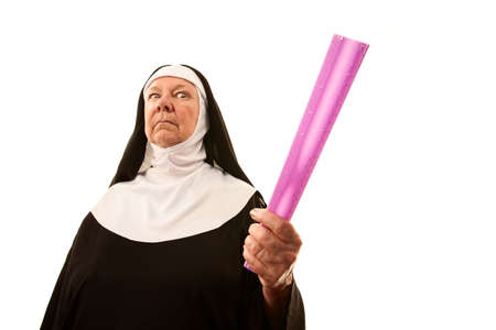 Angry senior nun brandishing ruler as weaponの写真素材