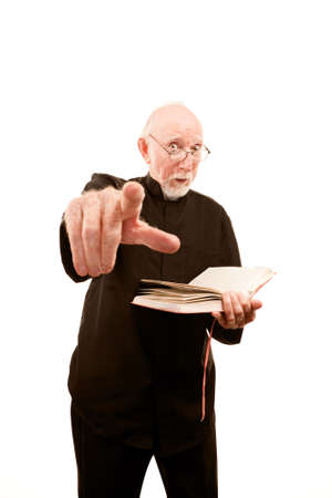 Angry priest or pastor giving fiery sermon from Bibleの写真素材