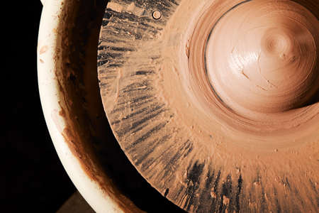 Detail of potters wheel with lump of wet clayの写真素材