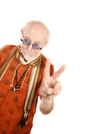 New age senior man in orange shirt making peace signの写真素材