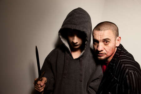 Evil boy with long dagger and male zombie sidekickの写真素材