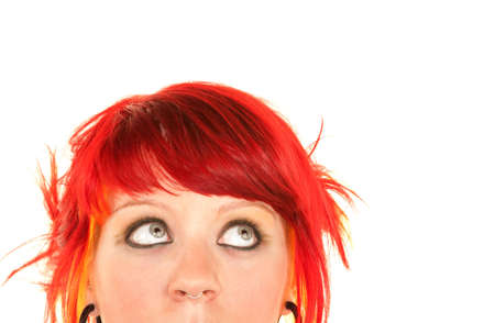 Pretty punky girl with brightly dyed red hairの写真素材