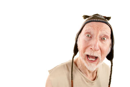 Senior man with surprised expression wearing knit cap