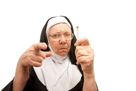 Stern nun reprimanding over a discovered cigaretteの写真素材