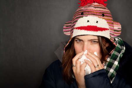 Pretty young woman with either flu or coldの写真素材