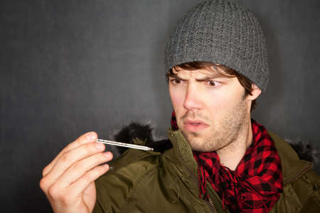 Handsome young man with either flu or cold