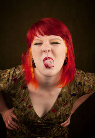 Pretty punky girl with brightly dyed red hair