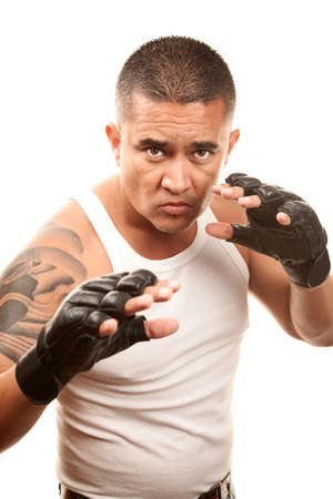 Hispanic man in t-shirt wearing mixed martial arts glovesの写真素材