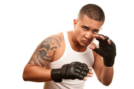 Hispanic man in t-shirt wearing mixed martial arts glovesの写真素材