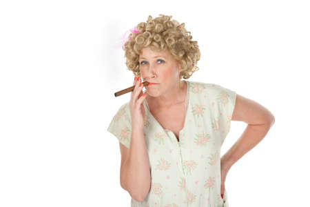 Housewife with cigar and hands on hips on white backgroundの写真素材