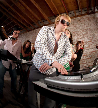 Handsome DJs playing music at a 1970s Disco Music Party