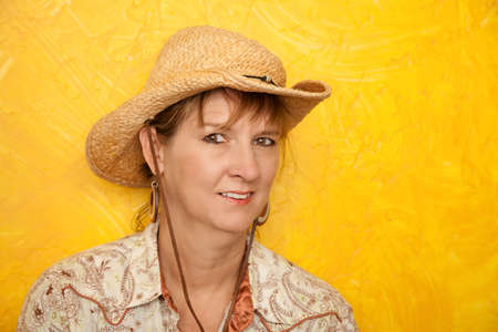 Pretty western woman in cowboy shirt and hatの写真素材