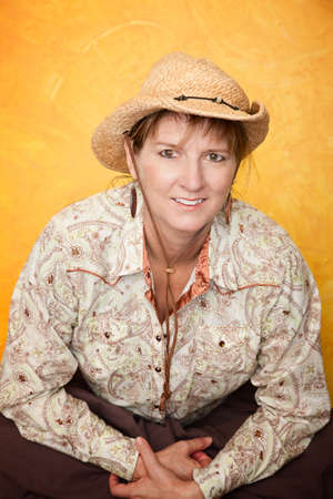 Pretty western woman in cowboy shirt and hatの写真素材