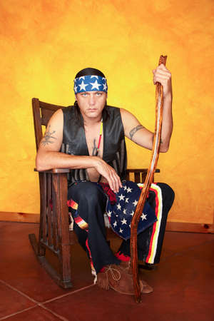 Kneeling Native American man in rocking chairの写真素材