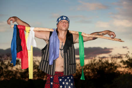 Indigenous man with ceremonial pole representing seven driectionsの写真素材