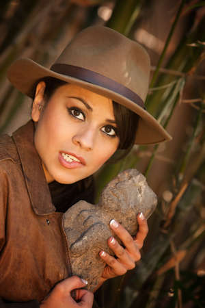 Pretty adventurer with stolen relic in thick green bamboo forestの写真素材