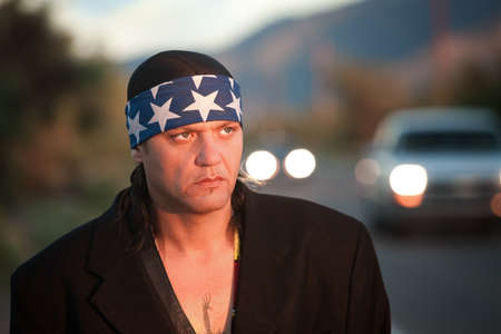 Handsome indigenous man by the side of the road