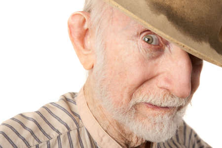 Grungy senior cowboy with a sweat-stained hat