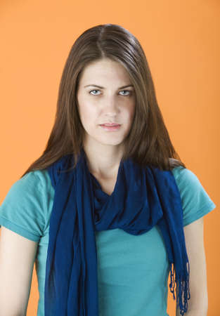Pretty Young Woman with Long Hair on Orange Background