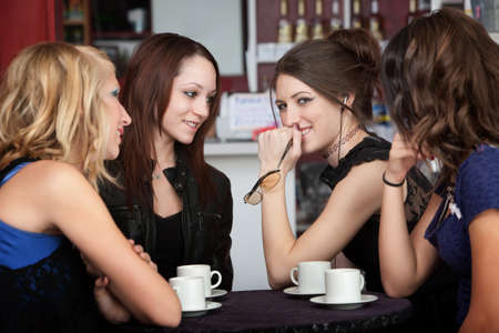 A cute teenaged girl knows something her friends don't knowの写真素材