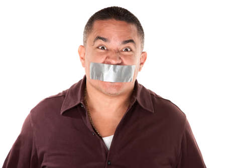Angry Hispanic man with duct tape over his mouthの写真素材