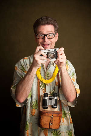 Nerdy pacific island tourist with a silly grin, camera and binocularsの写真素材