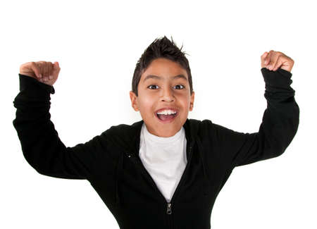 Cute Latino boy smiles with raised armsの写真素材