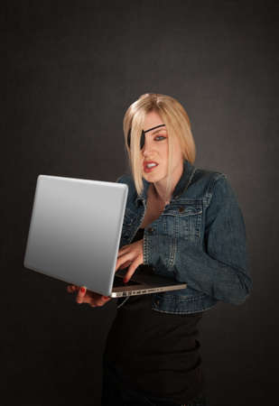 Young lady with eye-patch as a software pirateの写真素材