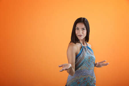 Young Hispanic woman shows something with an open empty handの写真素材