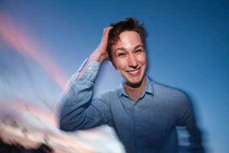 Young Caucasian man outdoor with hand on head