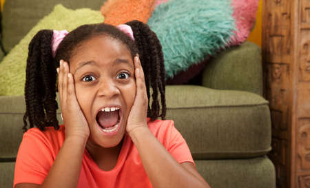 Scared African American girl in a roomの写真素材