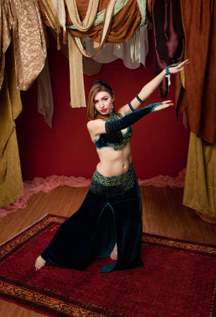 Beautiful woman belly dancing in a traditional dressの写真素材
