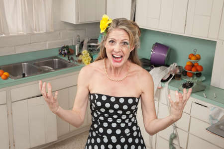 Angry Caucasian woman screams in her kitchenの写真素材