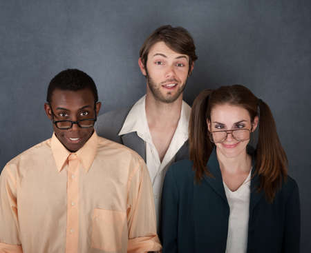 Mixed group of geeks on gray background smilingの写真素材
