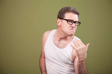 Annoyed Caucasian man in undershirt ready to fightの写真素材