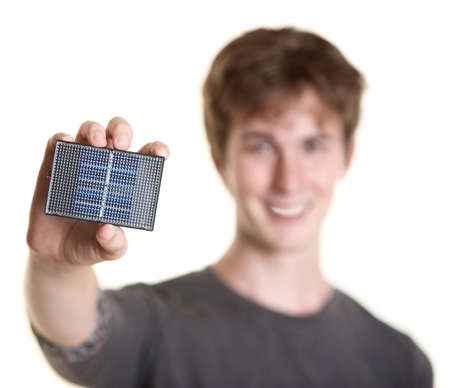 Smiling young man holds solar panel over white background