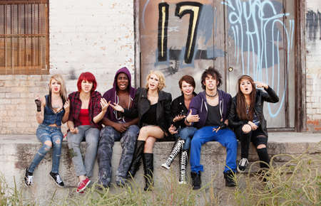 A group of young teen punks shout angrily as their photo is taken. A group of young teen punks shout angrily as their photo is taken.