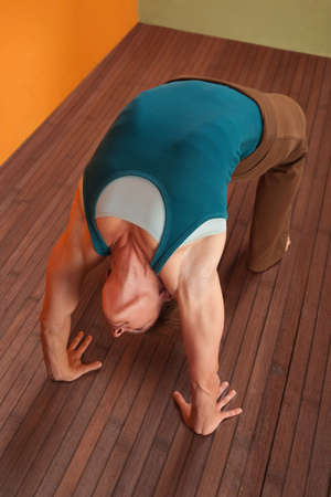 Fit young woman in Urdhva Dhanurasana posture