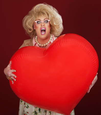 Screaming drag queen with huge red heart shaped balloonの写真素材