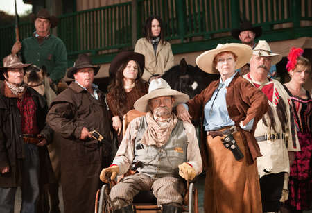 Wheelchair bound cowboy with wife and old west era gang