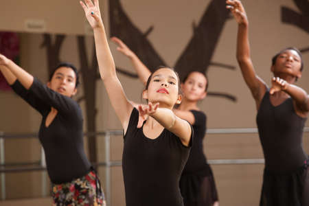 Four Black and Hispanic dance students practicingの写真素材