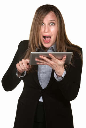 Excited woman holding tablet over white backgroundの写真素材