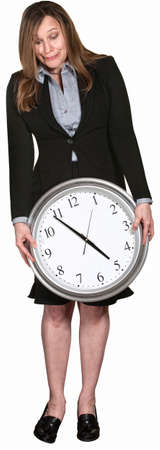 Businesswoman looking down at large clock over white background