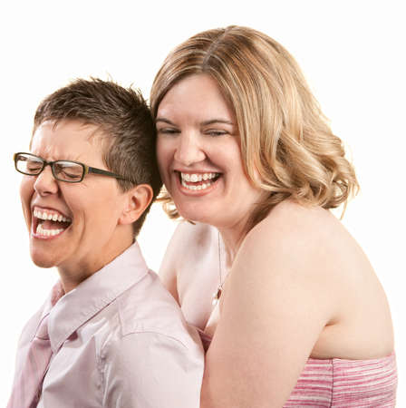 Two European friends laughing together over white backgroundの写真素材