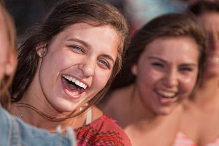 Close up of laughing European teenage girls outdoorsの写真素材