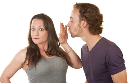 Unhappy woman blocking bearded man's kiss over white backgroundの写真素材
