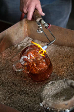 Blowtorch finishing fine art glass object in fritの写真素材