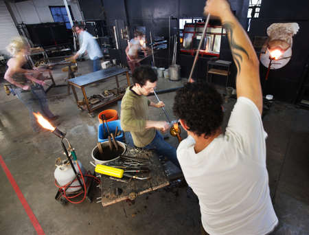 Busy group of male and female workers in factoryの写真素材