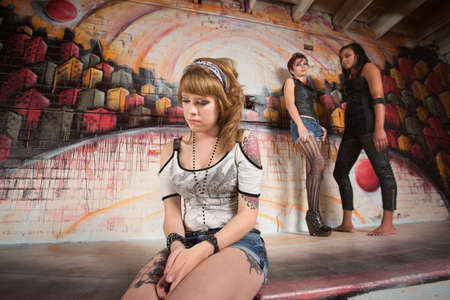 Ashamed young woman in shorts sitting alone